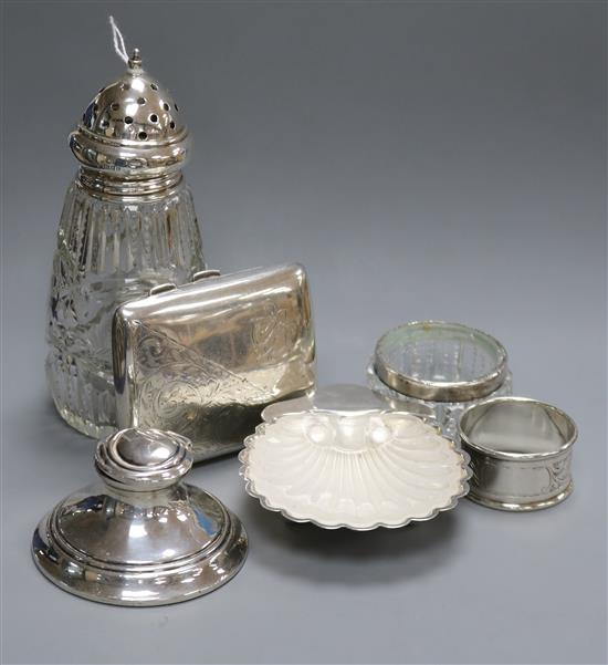 A 1930s silver butter shell with glass liner, a silver cigarette case, inkwell, etc.